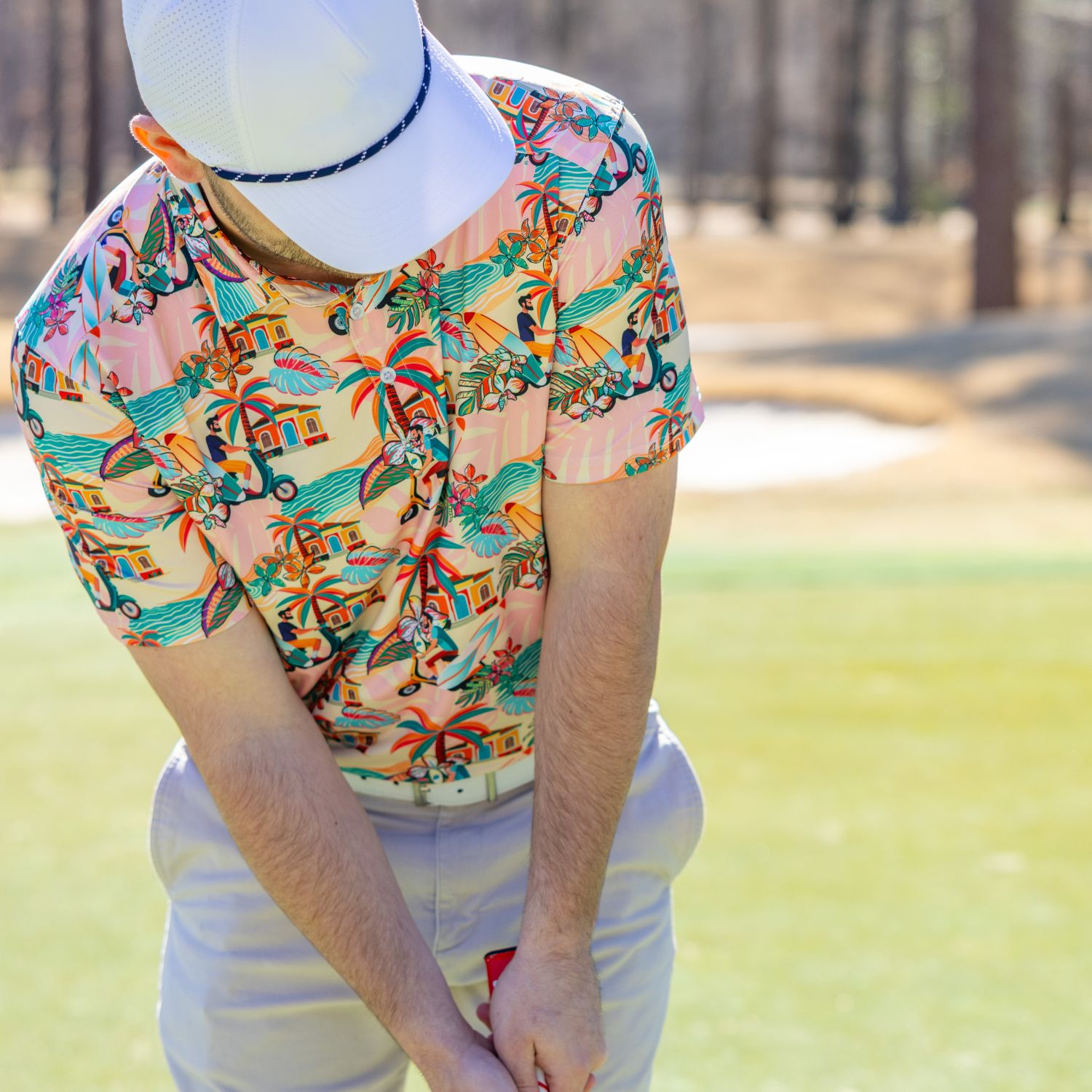 Mannequin wearing a colorful patterned shirt with a blurred outdoor background