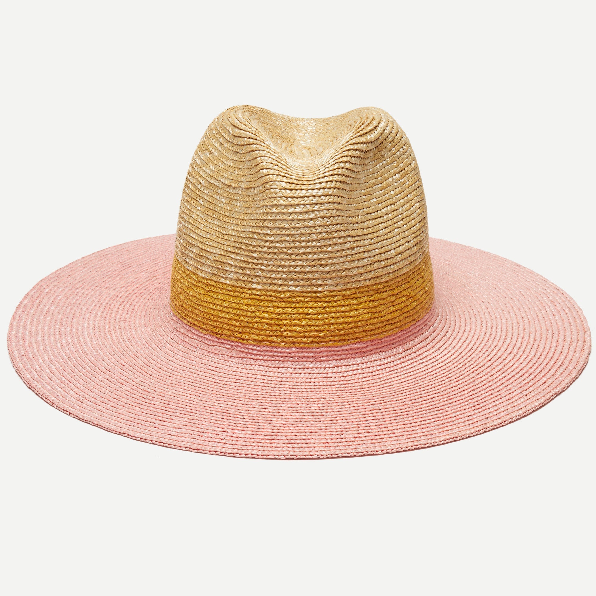 Two-toned straw hat with pink brim and gold crown on a white background
