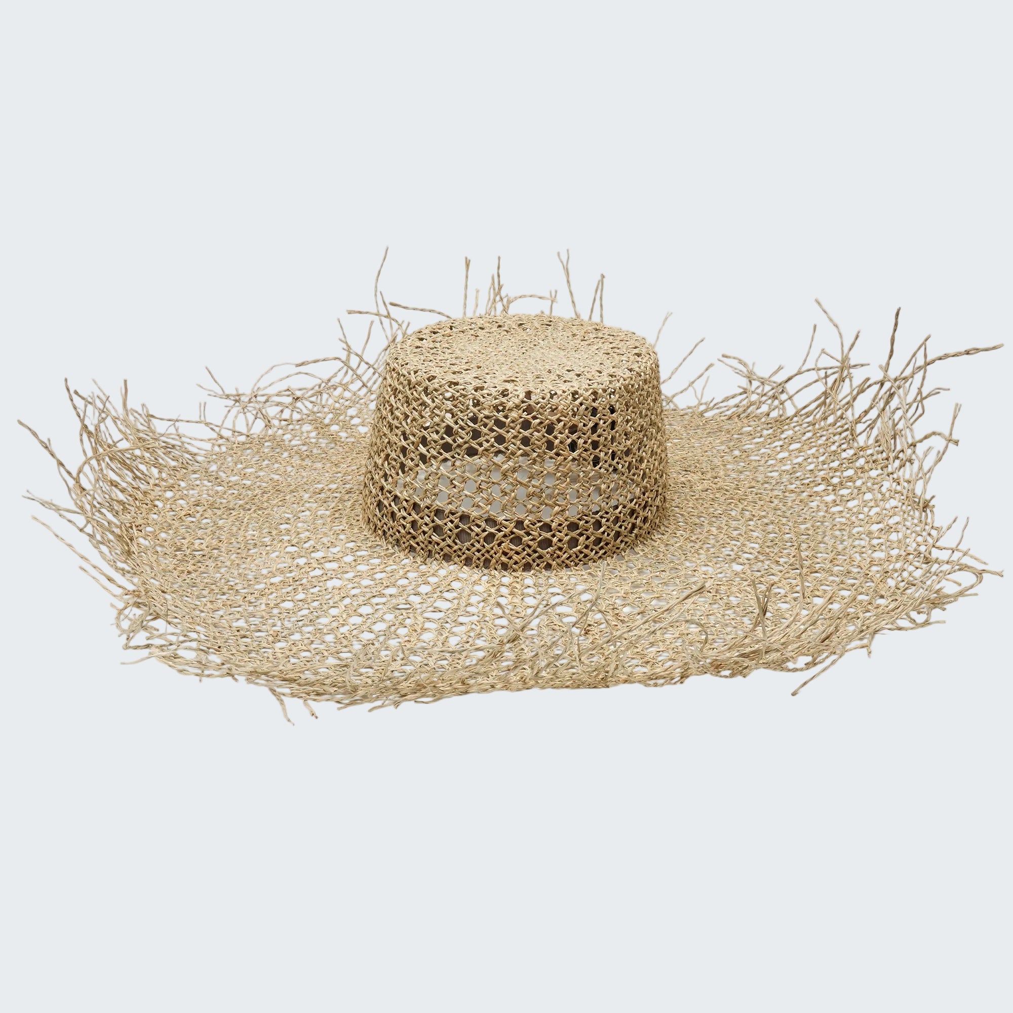 Beige straw hat with wide brim on a white background