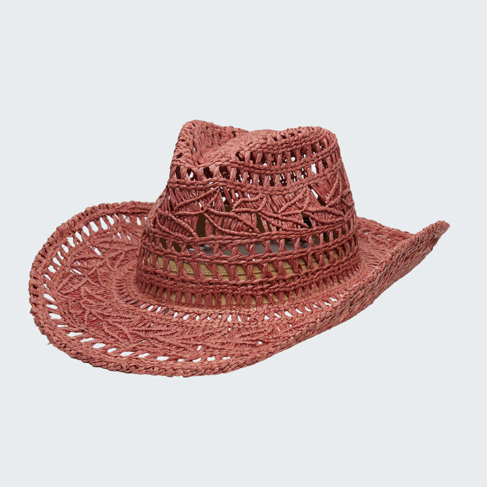 Pink straw hat with intricate patterns on a white background