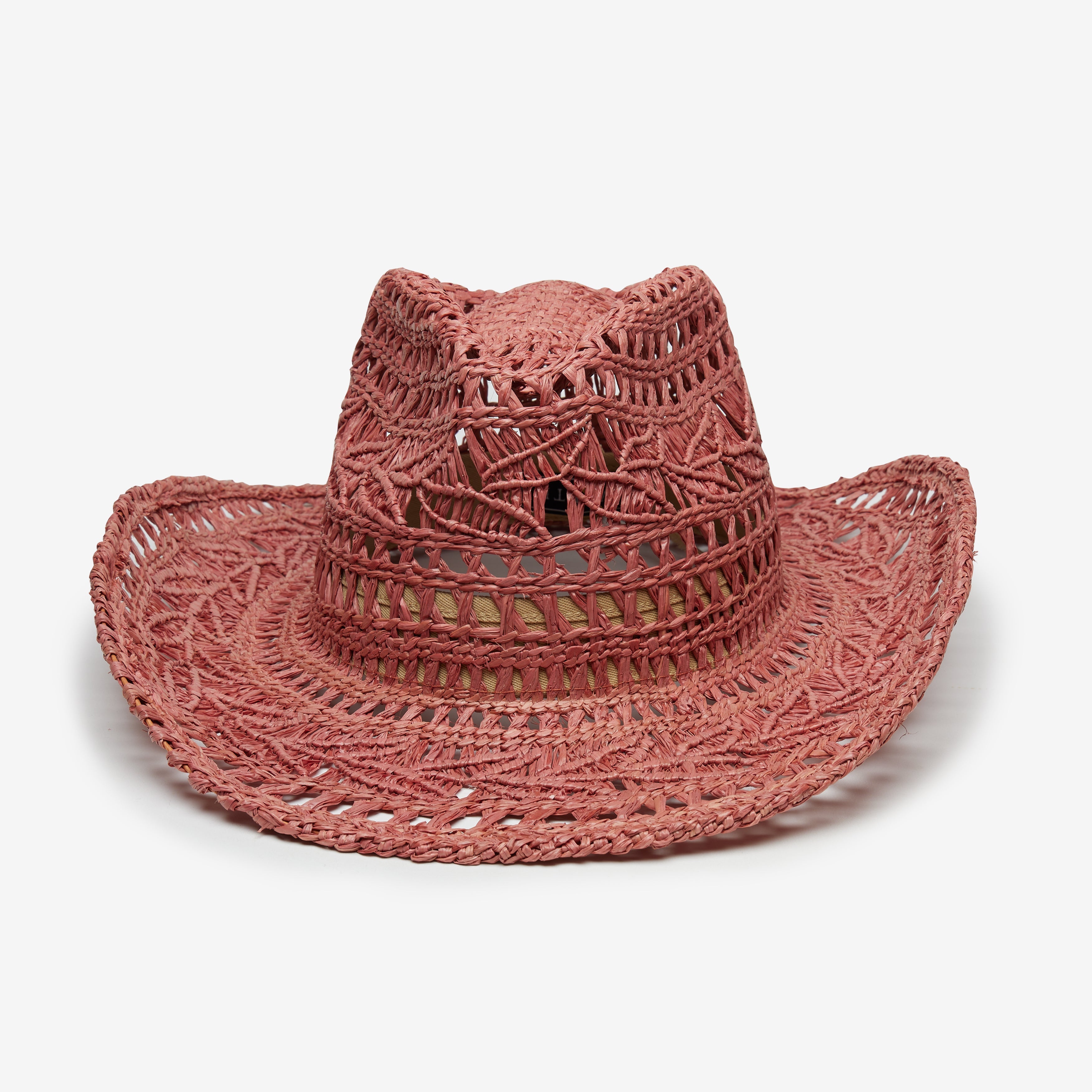 Pink straw hat with cut-out patterns on a white background