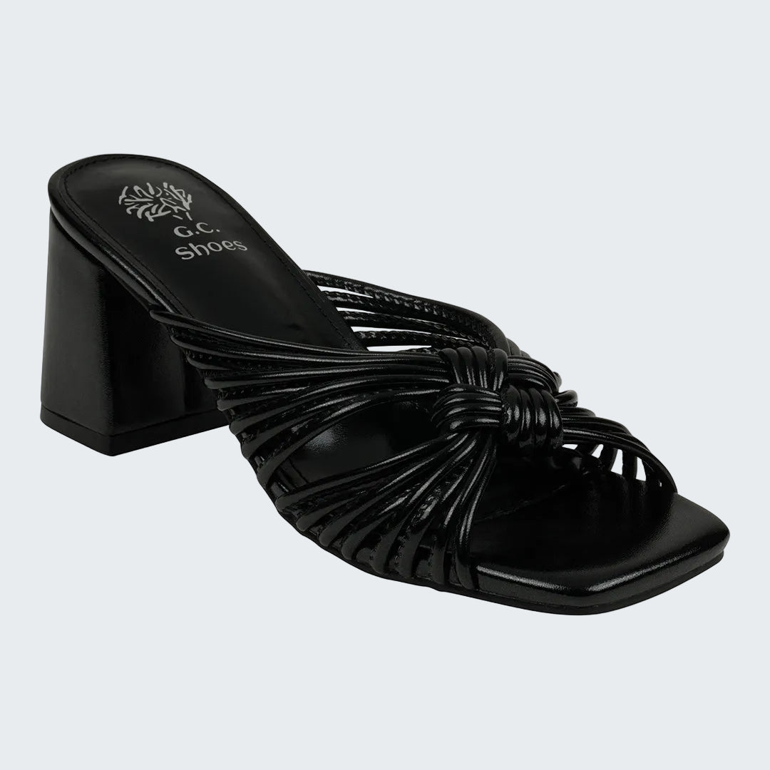 Black sandal with woven design and block heel on a white background