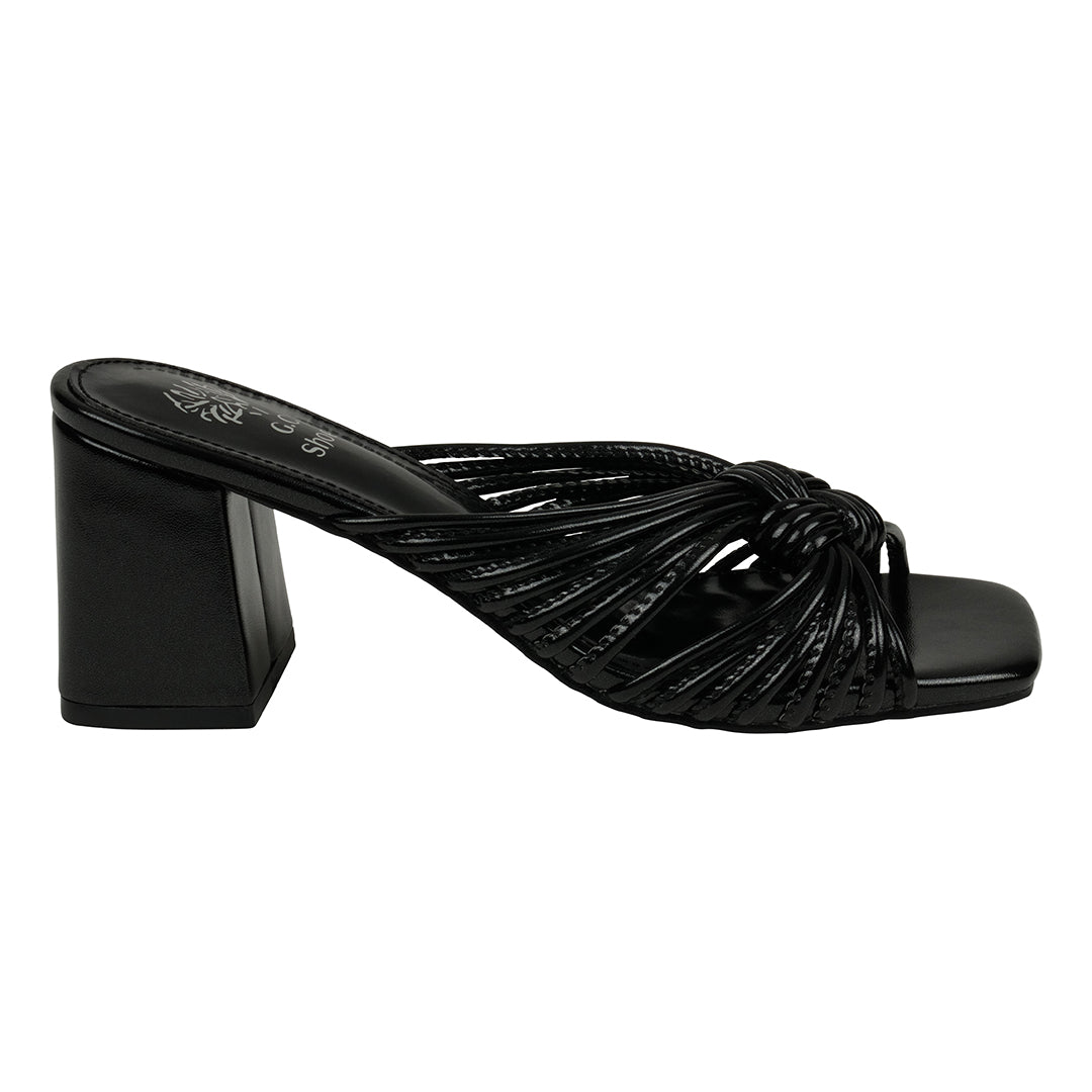 Black sandal with a knotted design on a white background