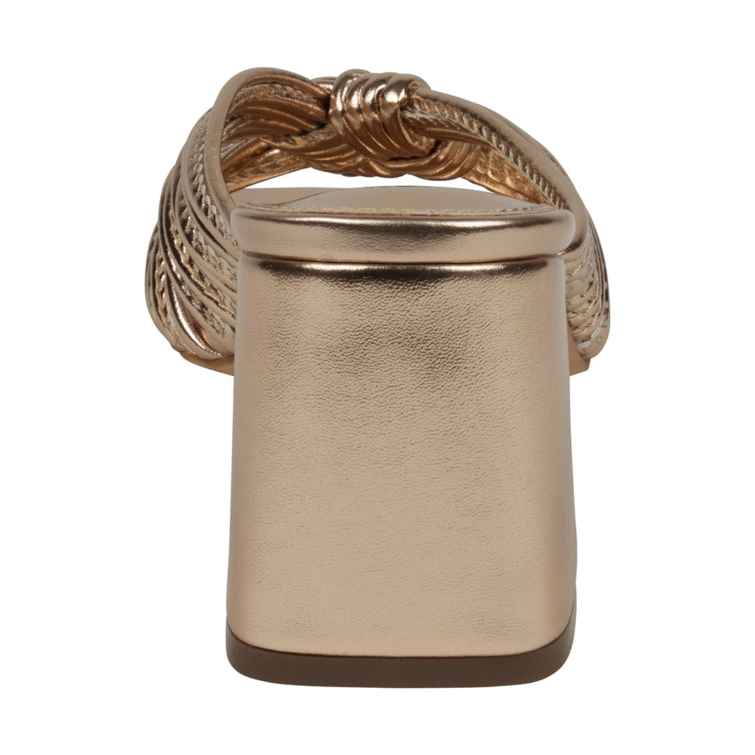 Gold ring with braided design on a white background