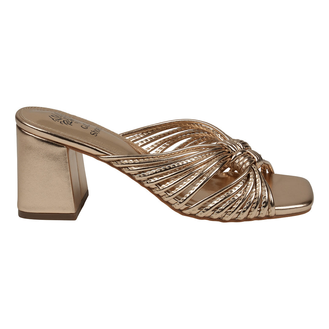Gold high-heeled sandal on a white background