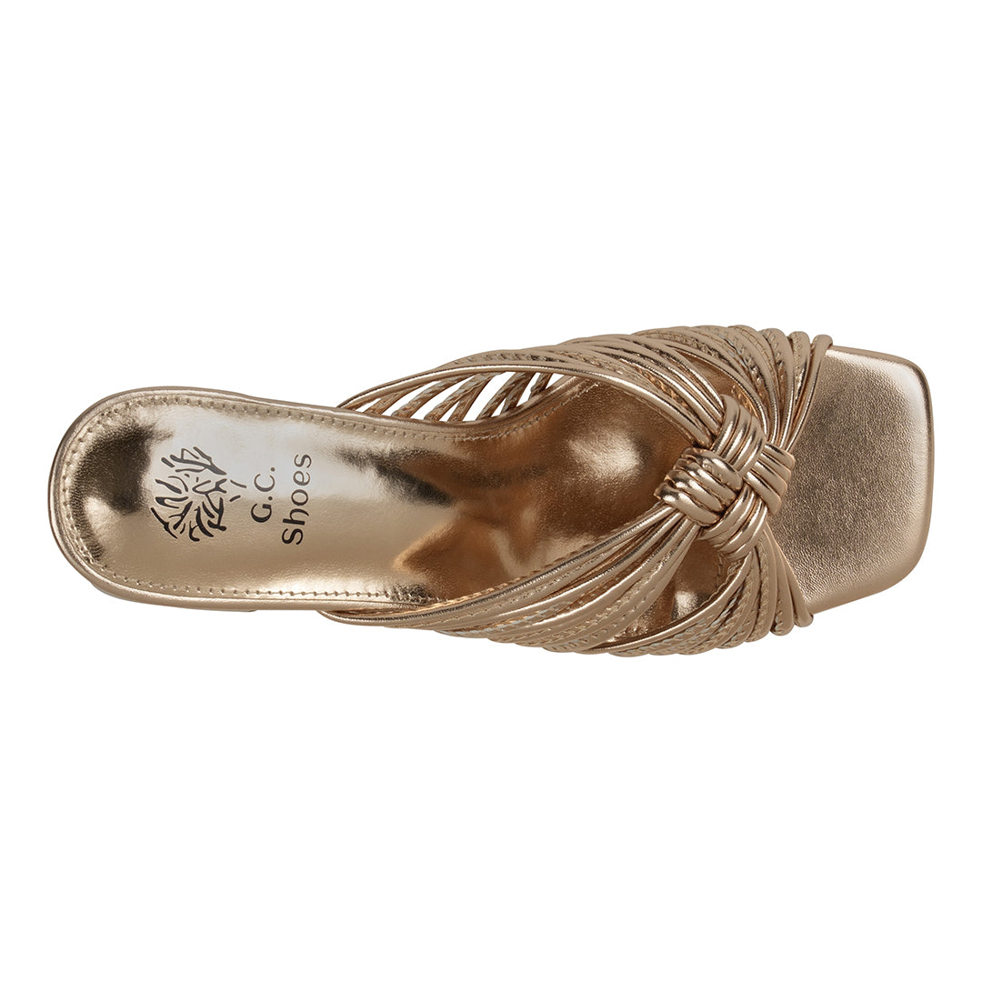 Gold sandal with 'G.C. Shoes' logo on a white background