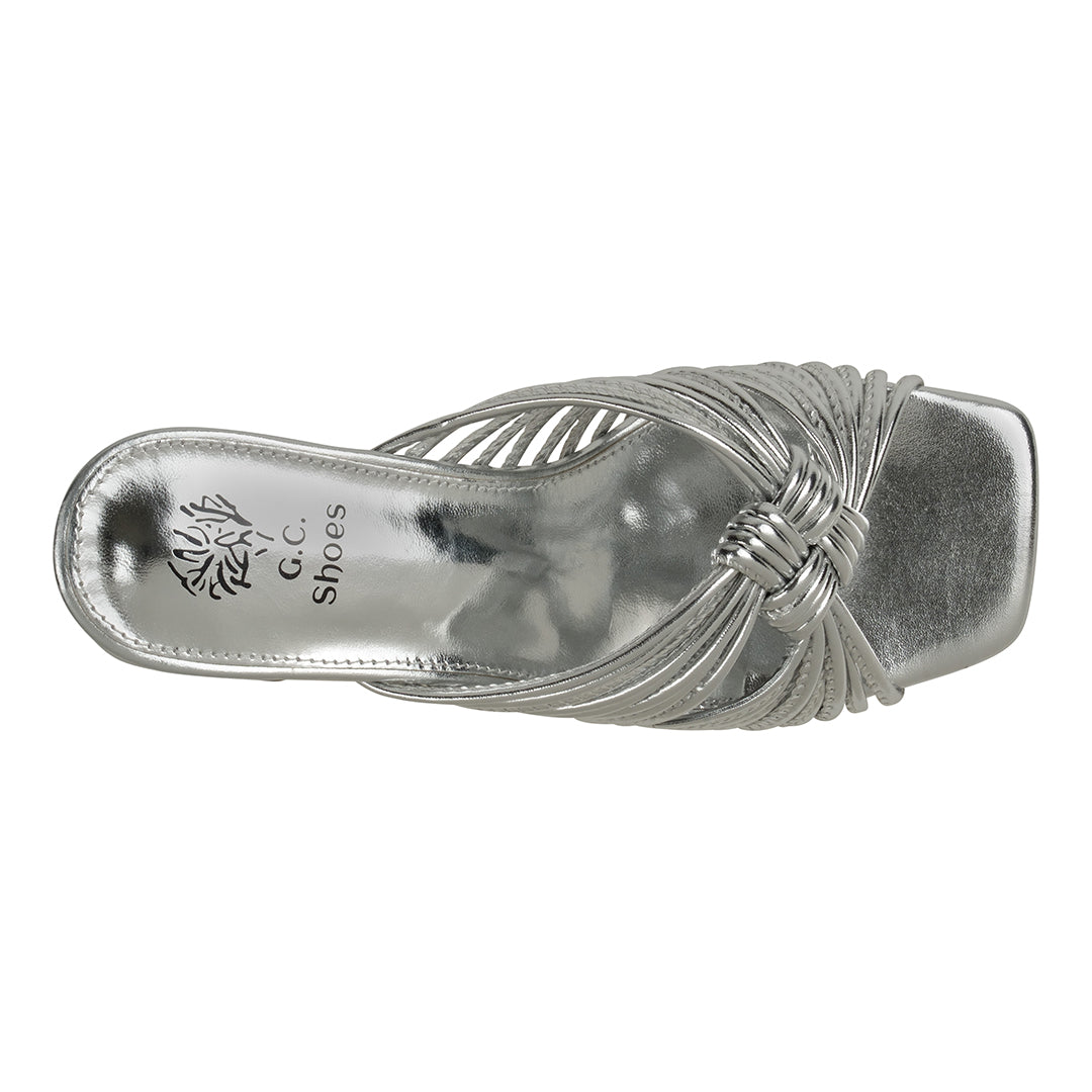 Silver sandal with decorative straps on a white background