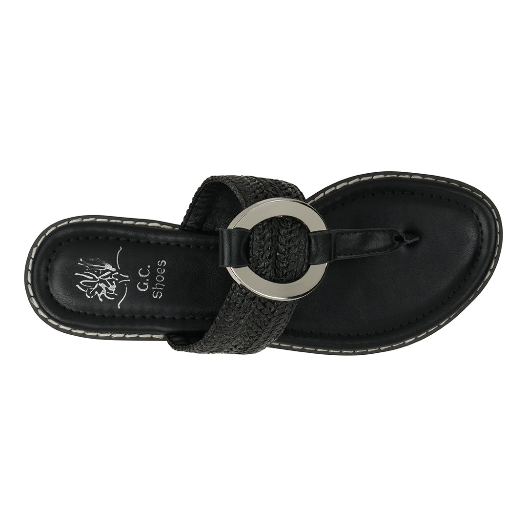 Black sandal with a circular metal buckle on a white background