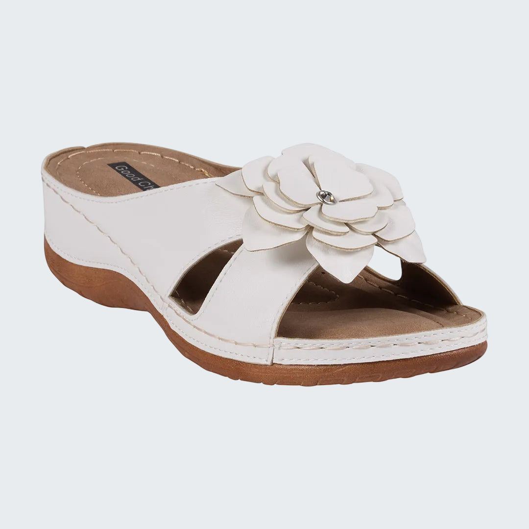 White sandal with a flower design on a white background