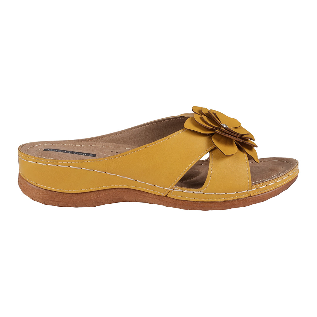 Yellow sandal with a flower detail on a white background