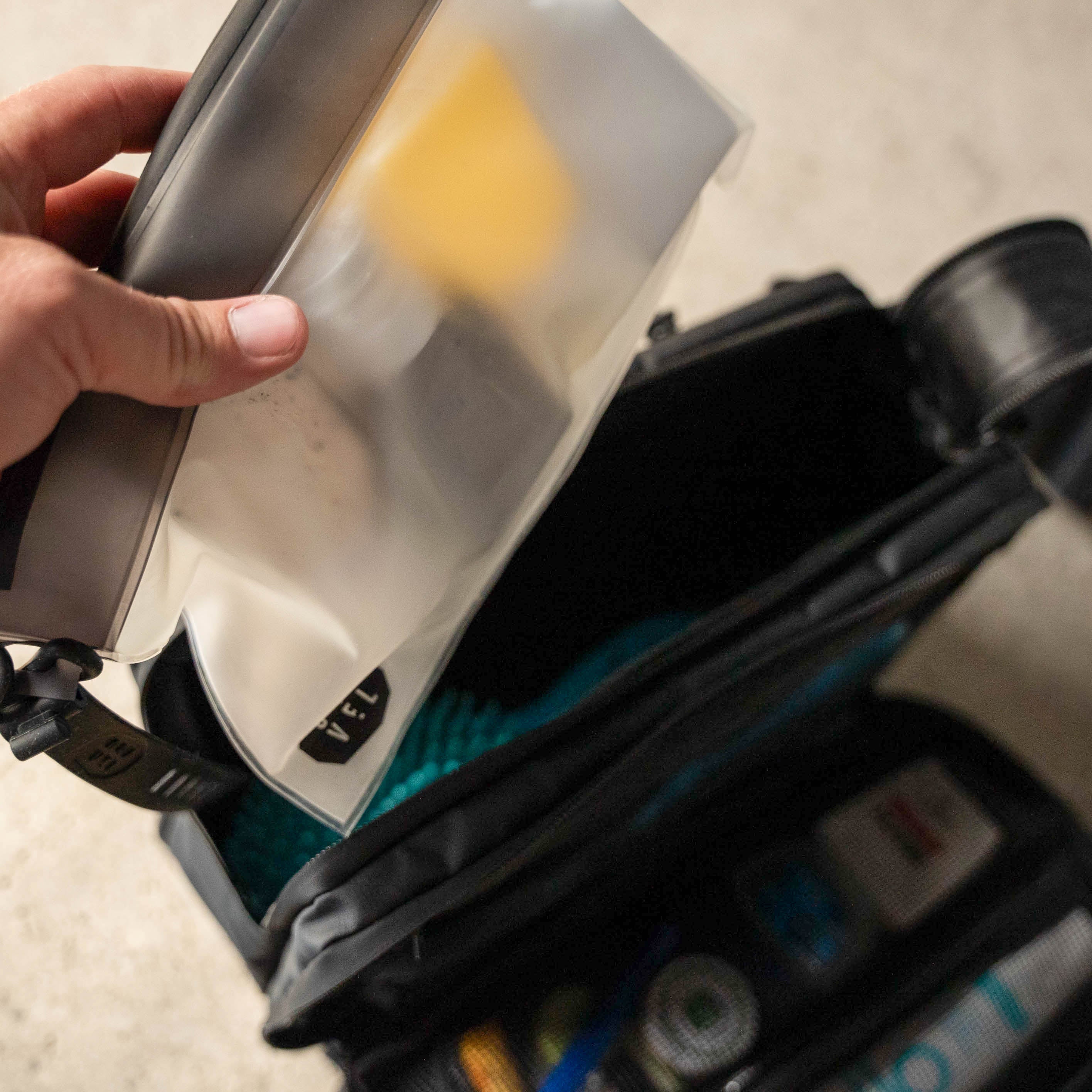 Person opening a tool case with various tools inside