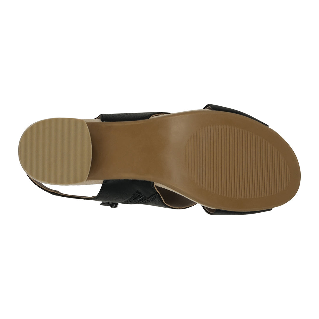 Black sandal with tan sole on a white background
