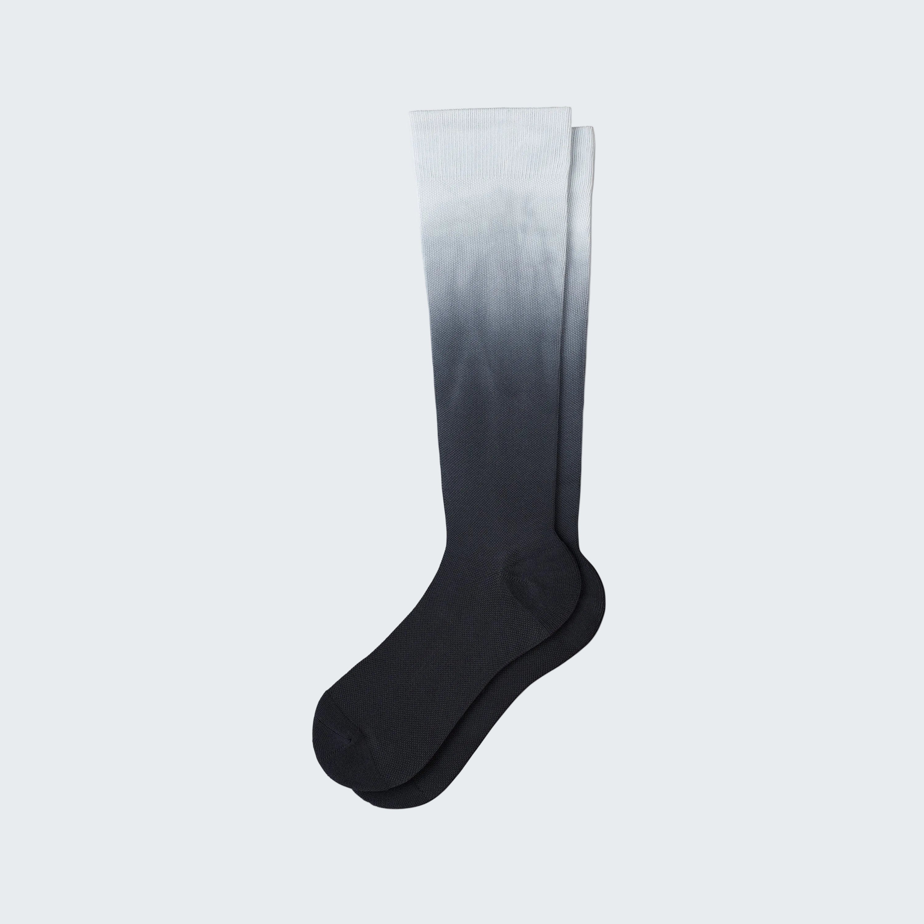 Knee-high sock with gradient color from white to black on a white background