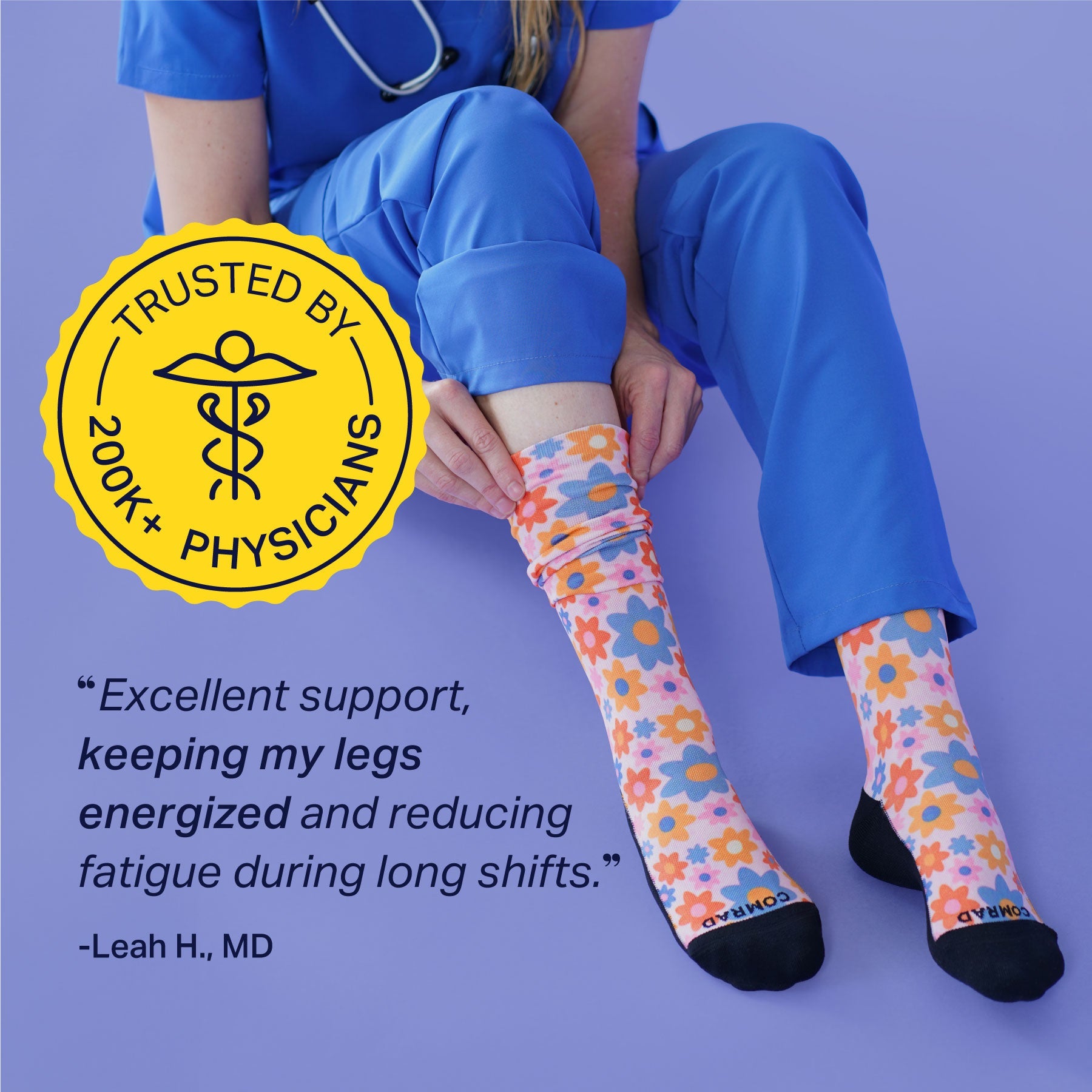 Person wearing colorful socks with a quote and badge on a purple background