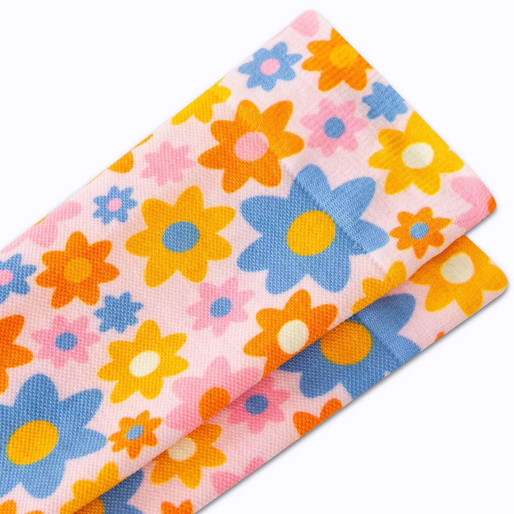 Two colorful fabric swatches with floral patterns on a white background