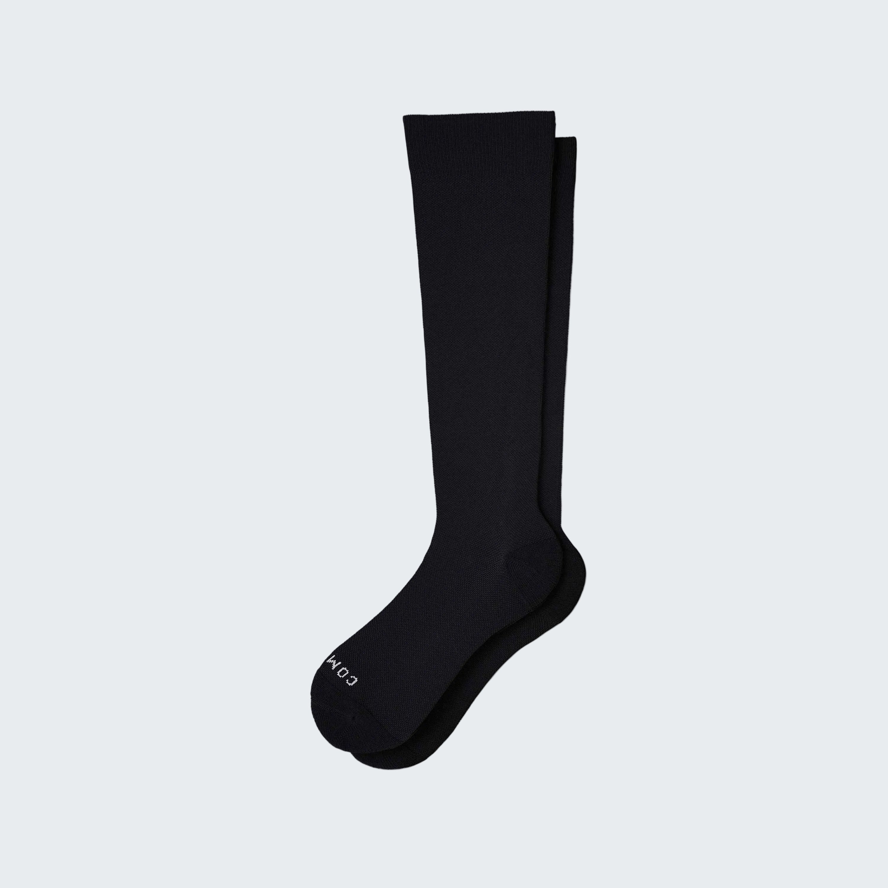 Black knee-high sock on a white background