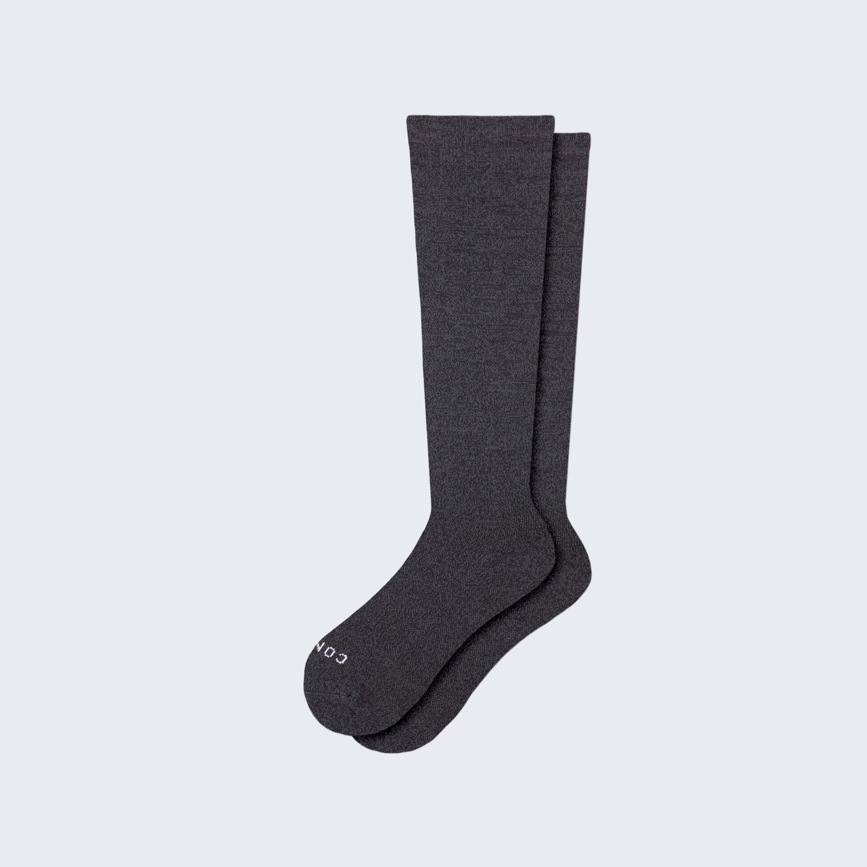 Pair of dark gray knee-high socks on a white background