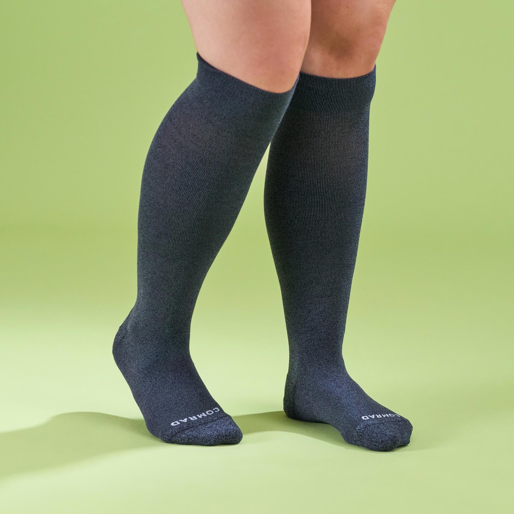 Knee-high socks worn by a person on a green background