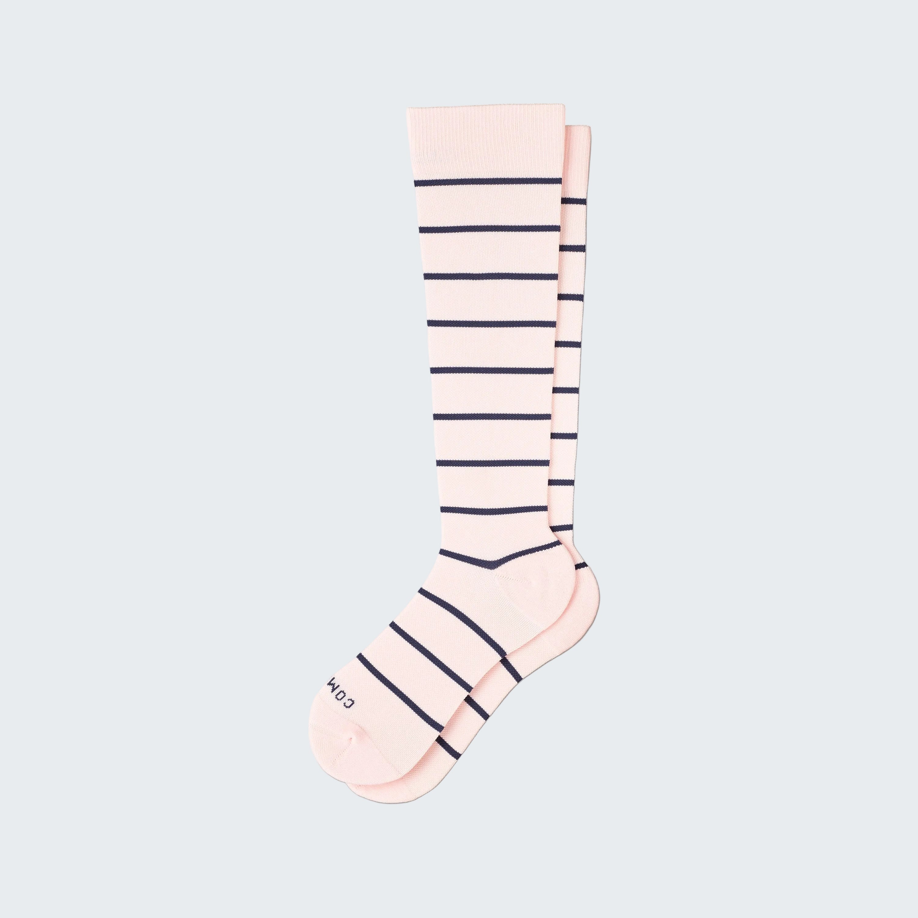 Pink knee-high sock with navy stripes on a white background