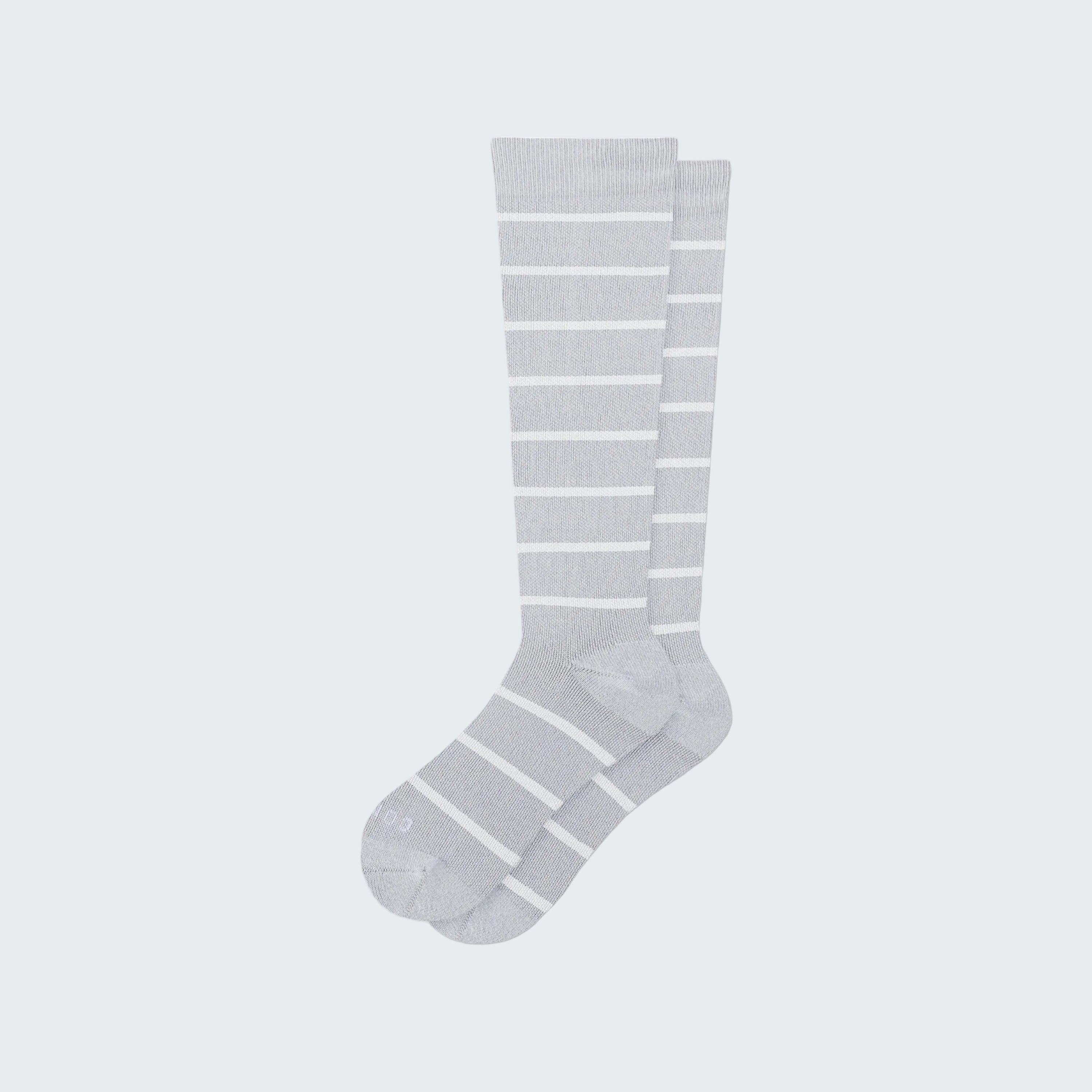 Gray knee-high socks with white stripes on a white background