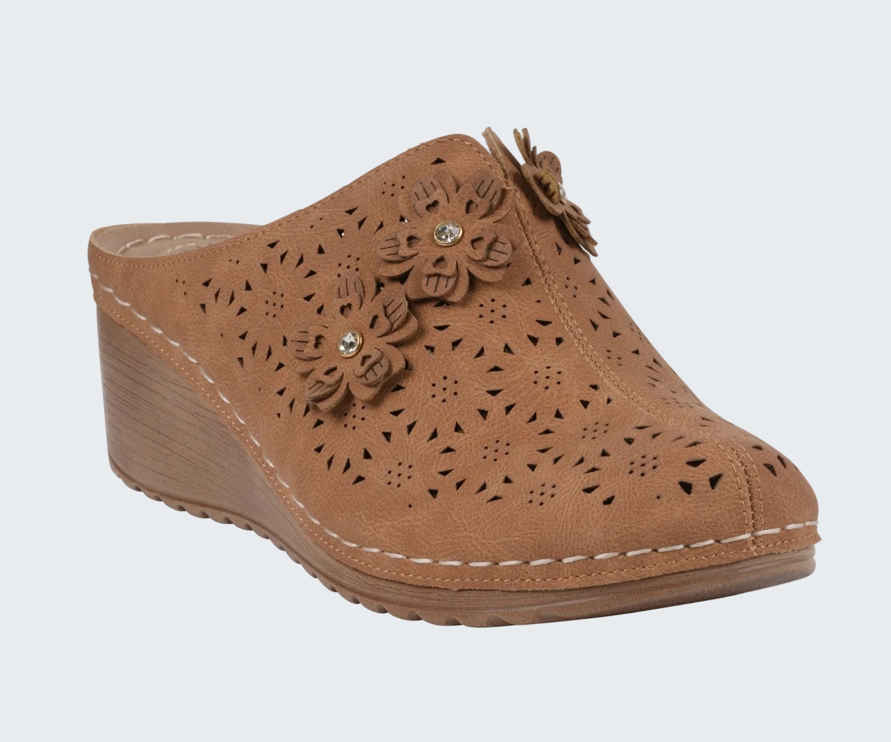 Brown wedge clog shoe with floral designs on a white background