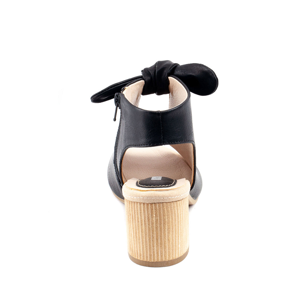 Black sandal with a bow on a white background
