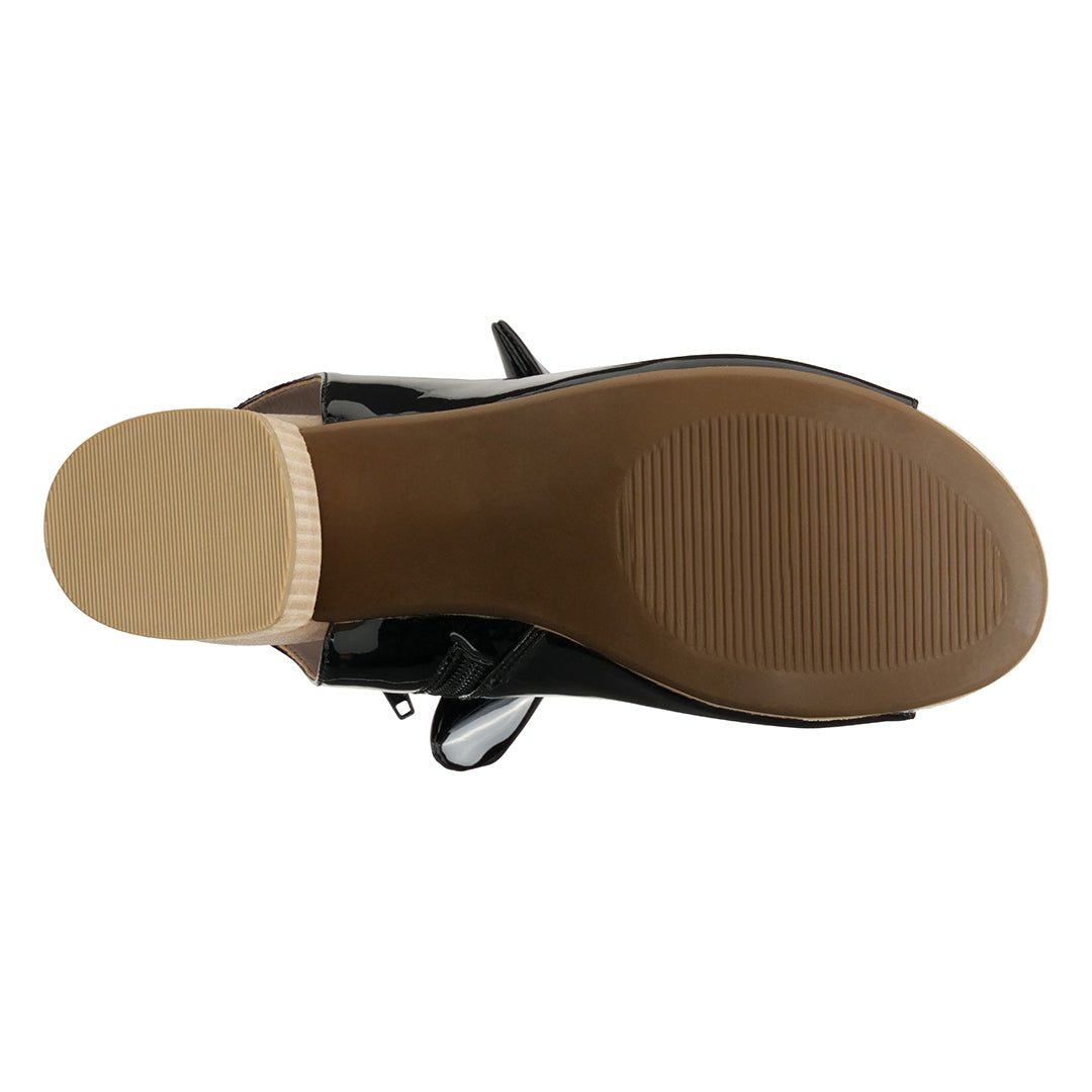 Black sandal with tan sole on a white background