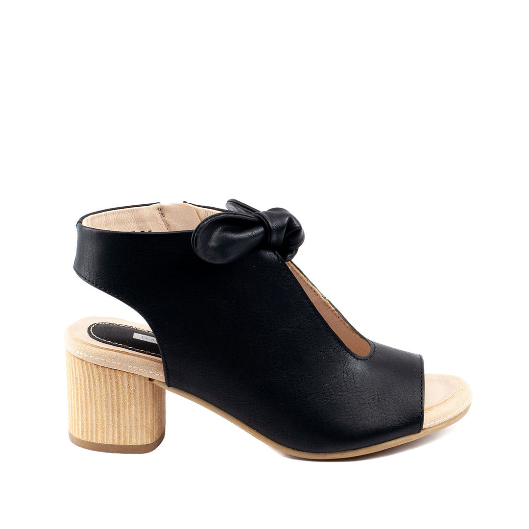 Black sandal with wooden block heel on a white background