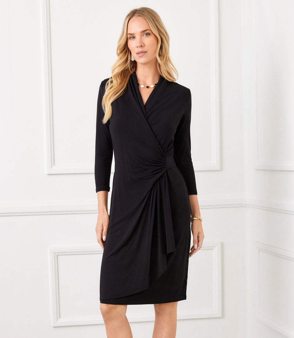 Woman wearing a black dress with a white background