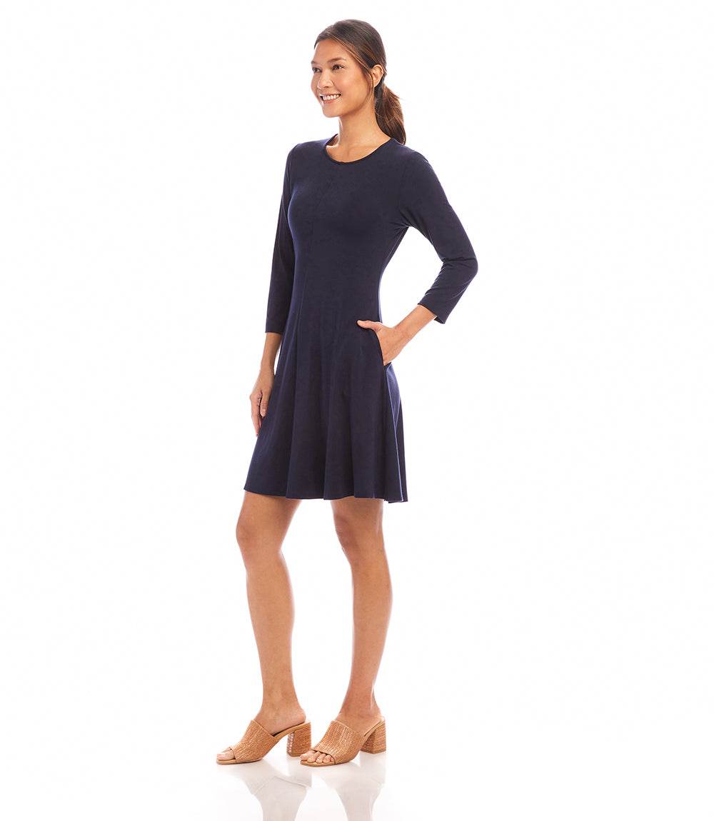 Woman wearing a navy blue dress on a white background
