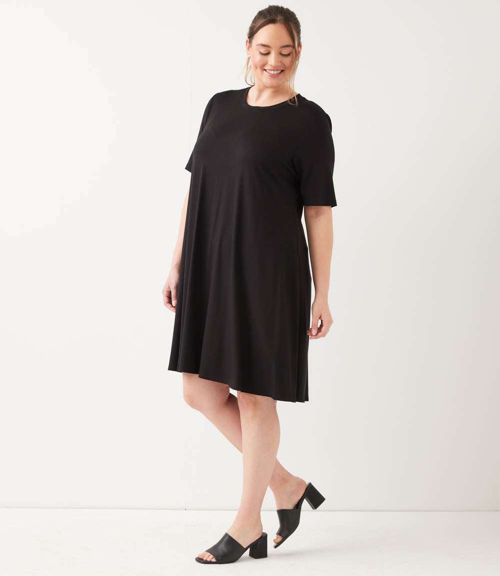 Woman wearing a black dress on a white background