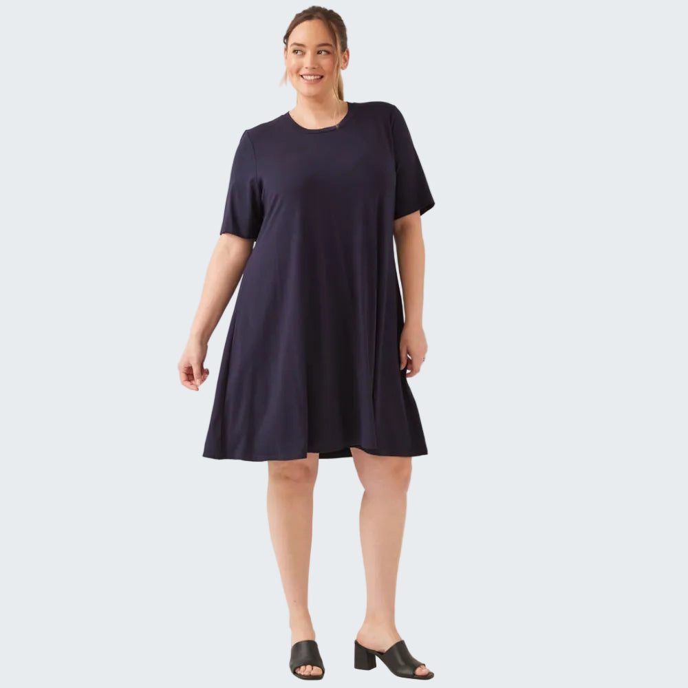 Woman wearing a navy blue dress on a white background