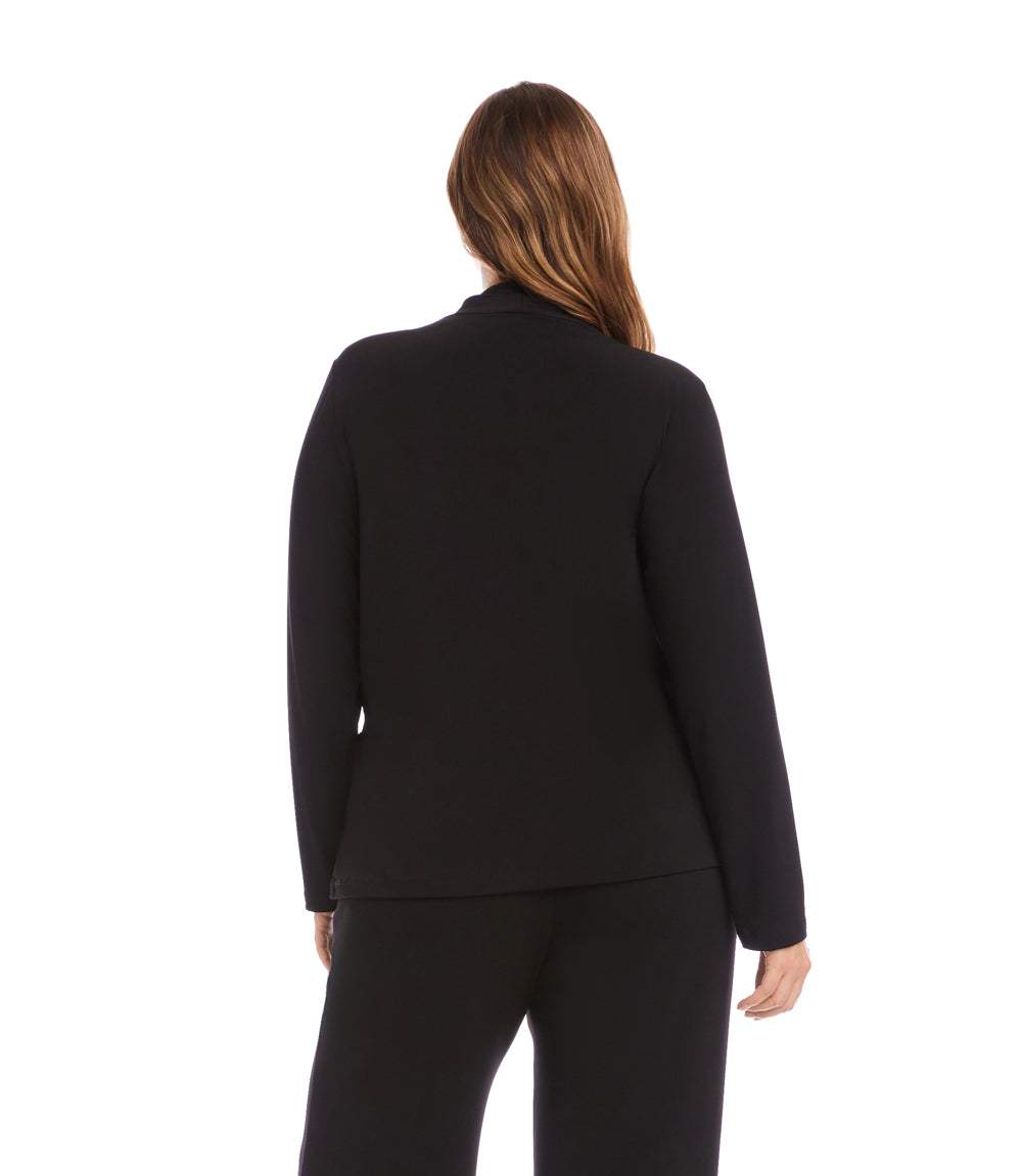 A woman viewed from the back wearing a black long-sleeve blazer and matching black pants against a plain white studio background.