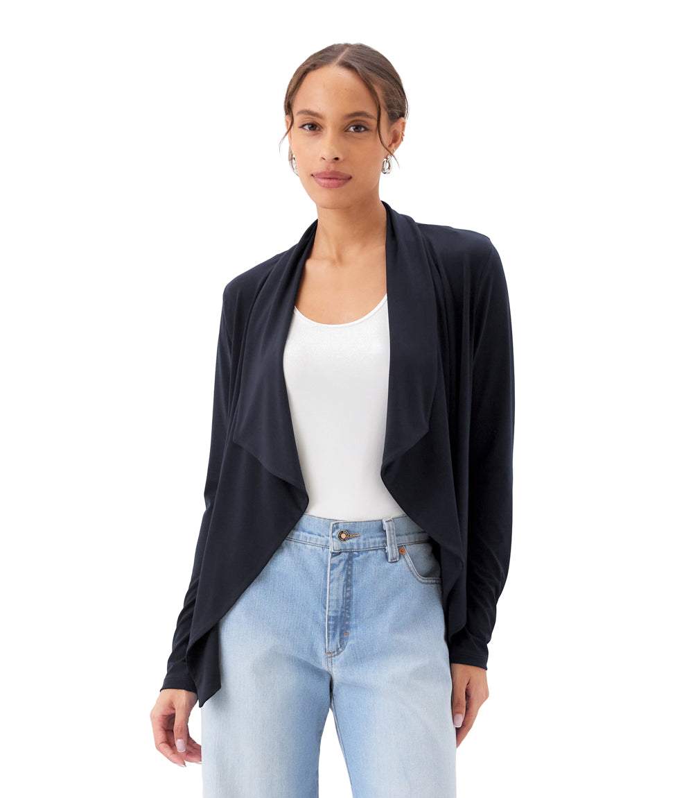 Woman wearing a black cardigan, white top, and light blue jeans on a white background