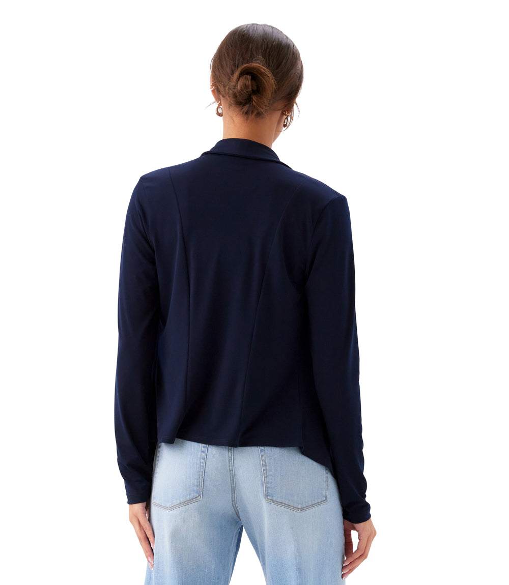Person wearing a navy long-sleeve shirt and light blue jeans on a white background