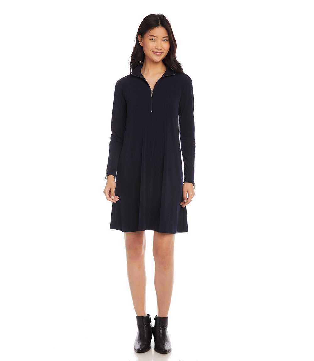 A woman modeling a dark navy long-sleeve shift dress with a half-zip neckline, shown against a plain white background.
