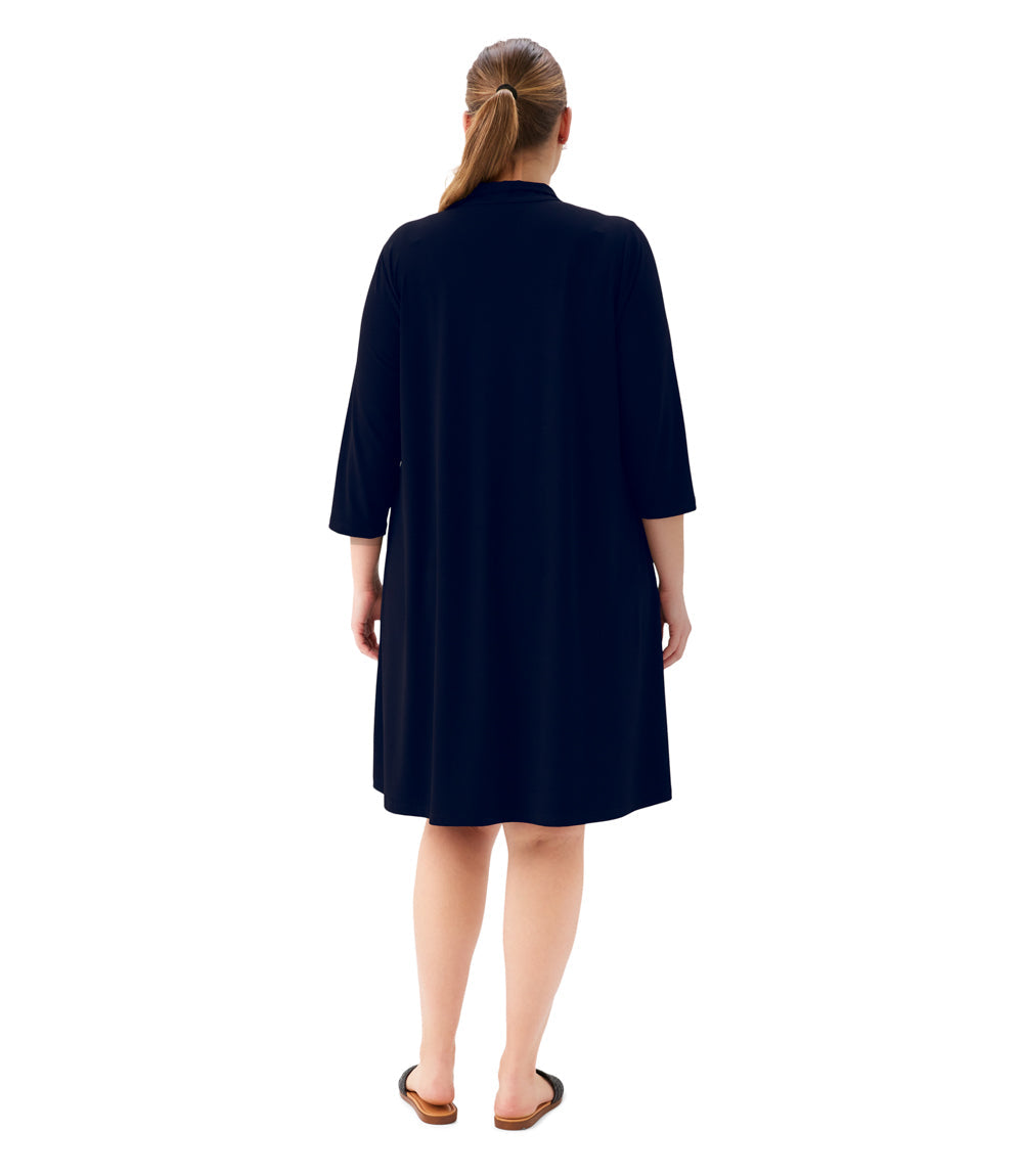 Person wearing a navy blue dress on a white background
