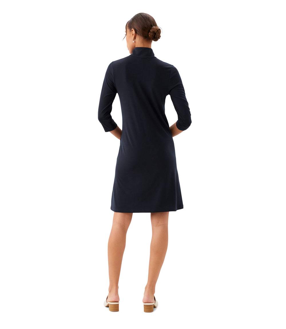 Woman wearing a black dress with long sleeves on a white background
