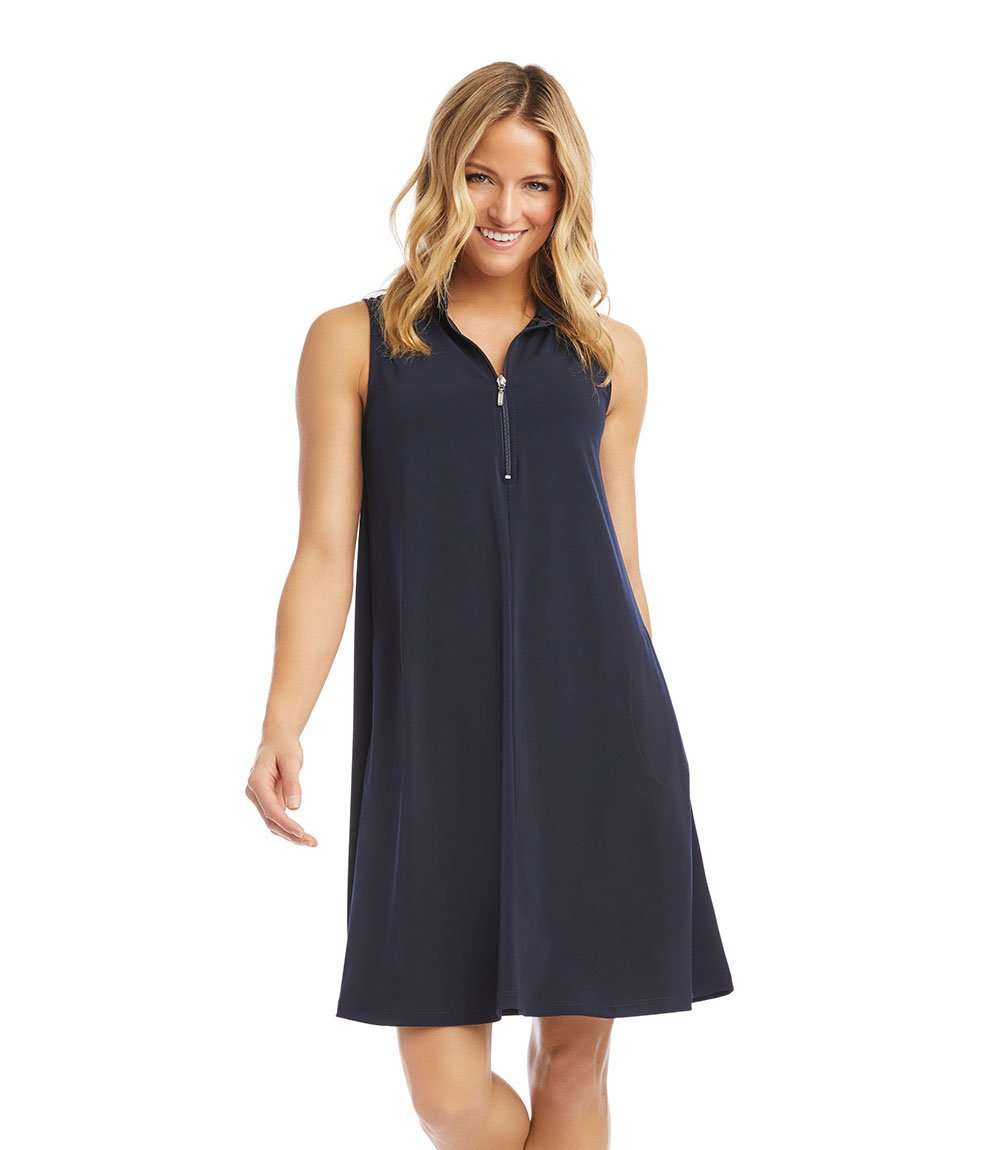 A woman modeling a sleeveless navy blue shift dress with a half-zip V-neckline, shown against a plain white background.