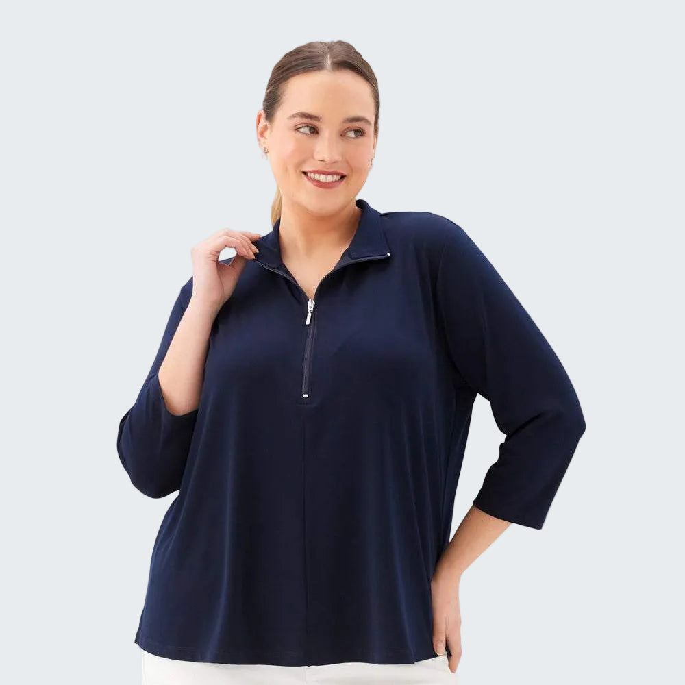 Woman wearing a navy blue zip-up top on a white background