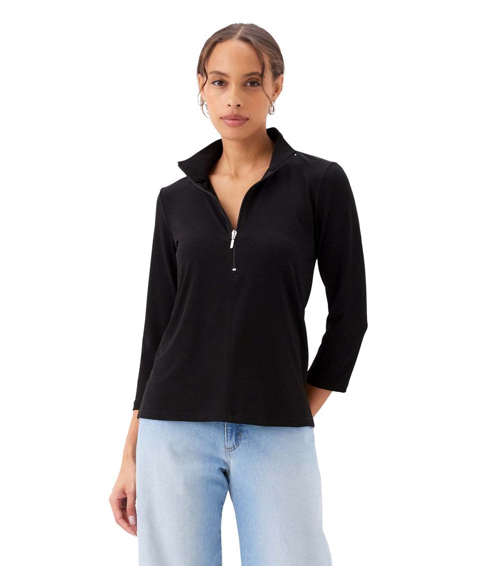 Woman wearing a black long-sleeve top with a zipper on a white background