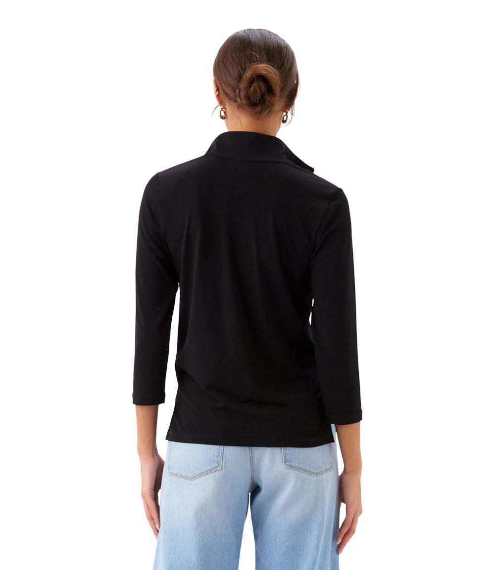 Person wearing a black jacket and light blue jeans on a white background