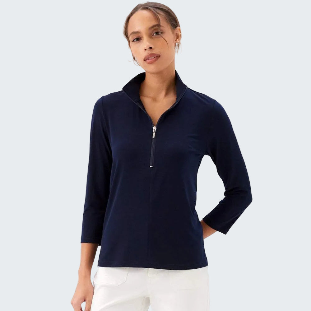 Woman wearing a navy blue long-sleeve top with a quarter zip on a white background