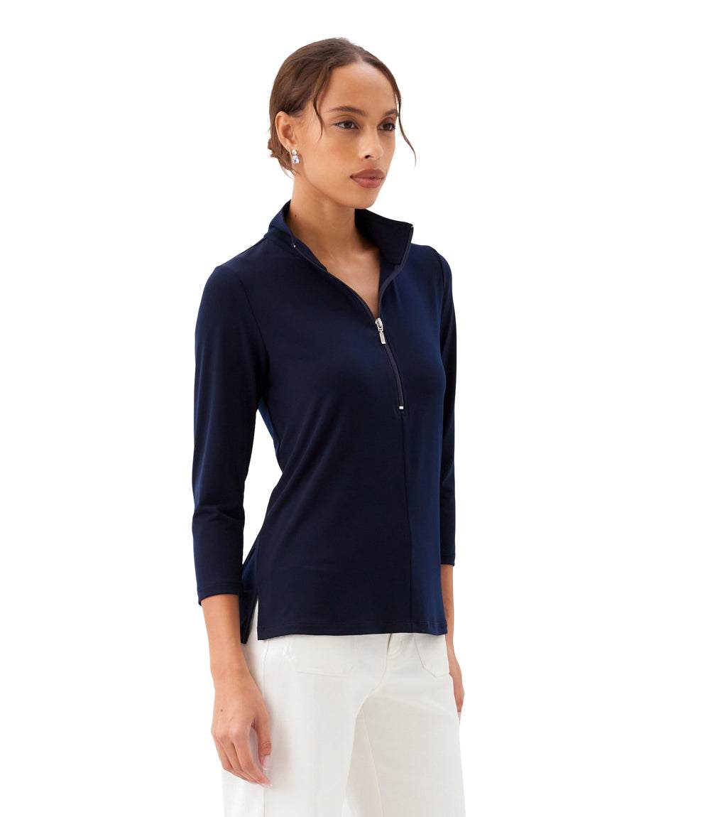 Woman wearing a navy long-sleeve top with a zipper on a white background