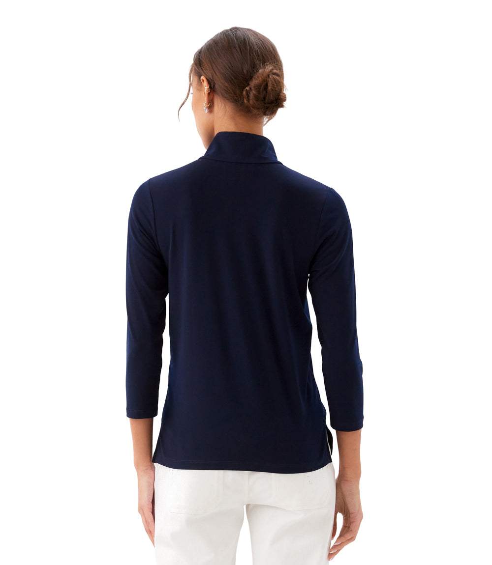 Woman wearing a navy long-sleeve top on a white background