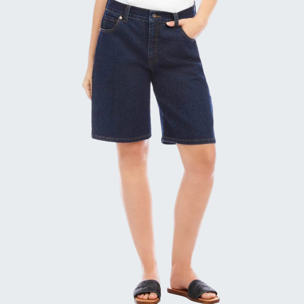 Person wearing dark denim shorts on a white background