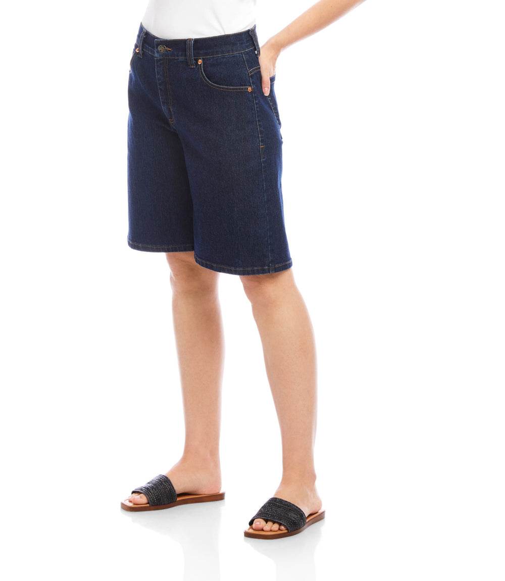 Person wearing dark blue denim shorts on a white background