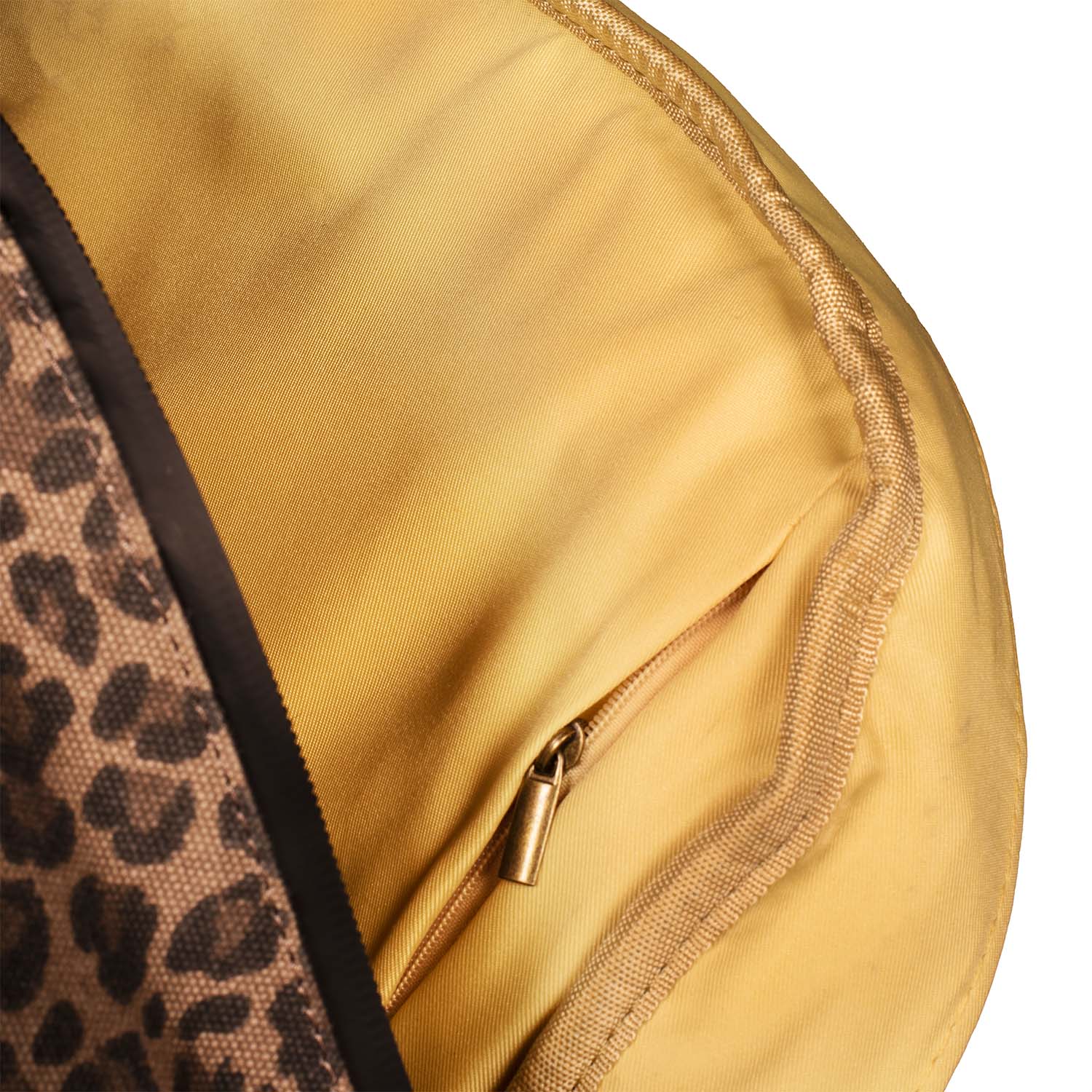 Close-up of a yellow fabric with a leopard print section and gold zipper.