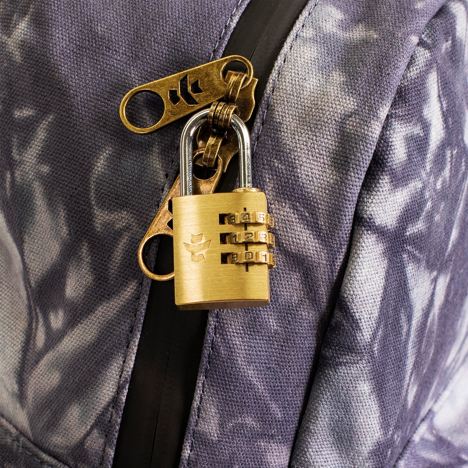 Gold padlock attached to a purple textured surface