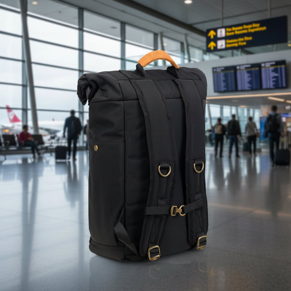 Black backpack with gold buckles on a white background